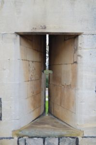 a stone archway with a cross