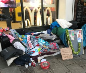 a pile of blankets and other items outside a mcdonald's restaurant