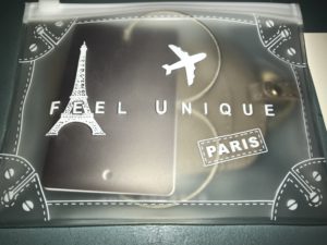 a clear plastic bag with a picture of a eiffel tower and a key chain