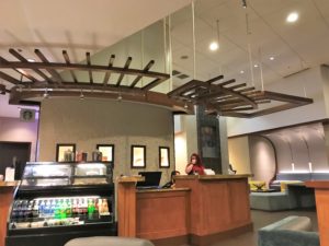 a woman standing at a desk in a hotel lobby