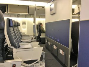 a plane with seats and a man sitting in the seat