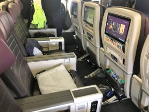 a row of seats with monitors