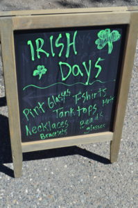 a chalkboard sign with green writing
