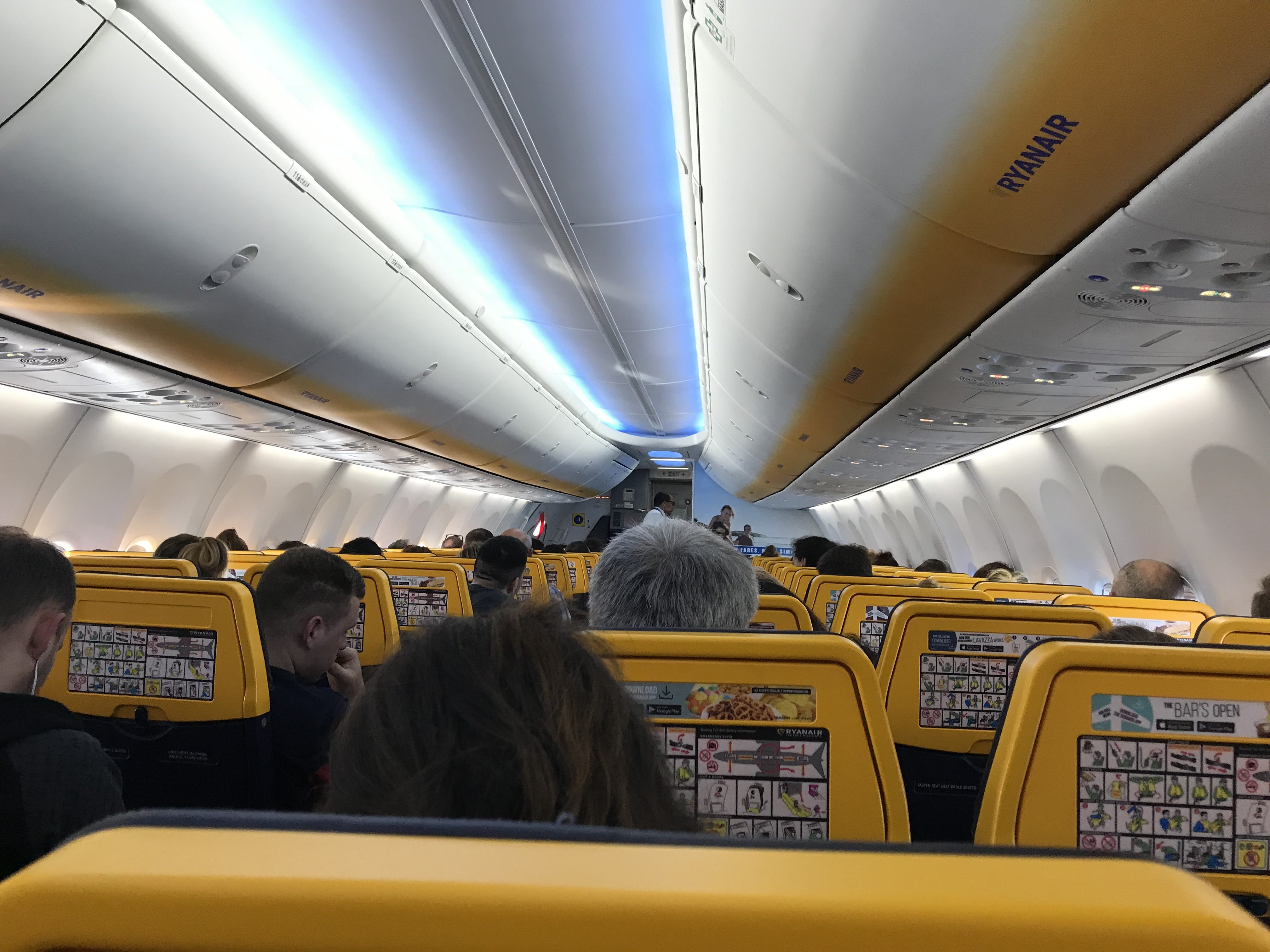 inside an airplane with people sitting in the seats