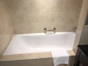 a bathtub with a towel on the side