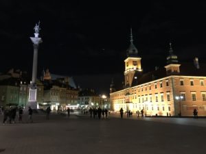 a building with towers and people in the background