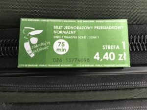 a green ticket on a black bag