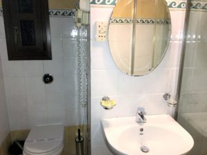 a bathroom with a round mirror