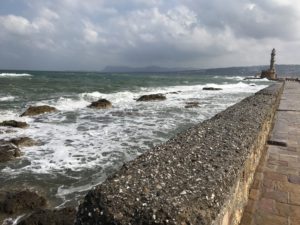 a rocky shore with waves crashing on the shore