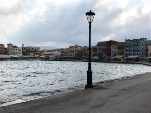 a street light next to a body of water