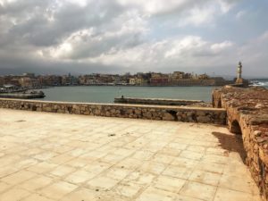 a stone patio with a body of water in the background