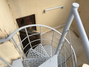 a spiral staircase with a metal railing