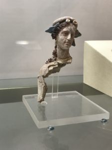 a statue of a woman's head on a glass stand