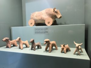 a collection of clay animals on a shelf