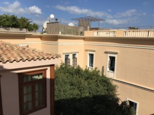 a building with a roof and trees