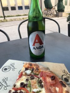 a bottle of beer and pizza