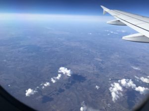 an airplane wing above the earth