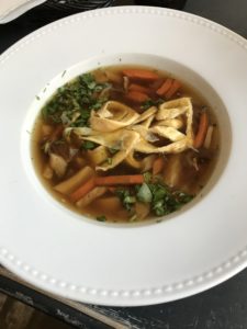 a bowl of soup with noodles and vegetables