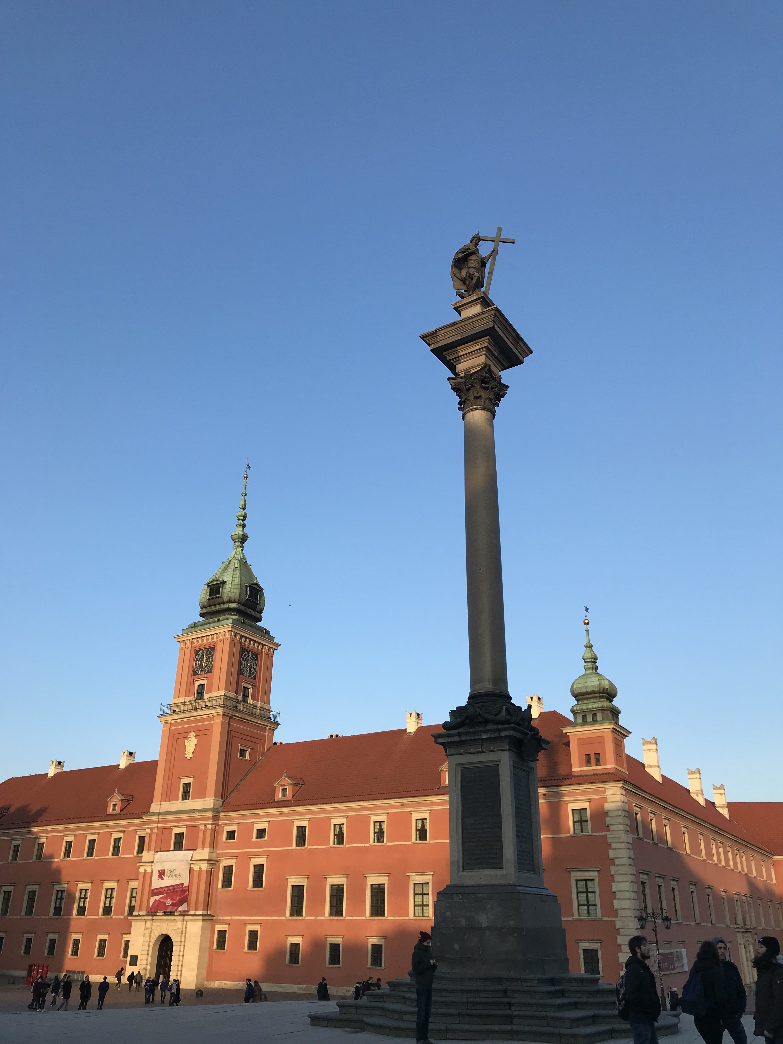 a statue on a pillar in front of Royal Castle, Warsaw