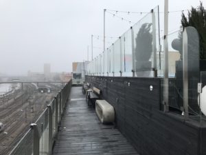 a walkway with a glass fence