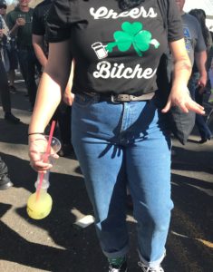 a woman wearing a black shirt with a clover on it