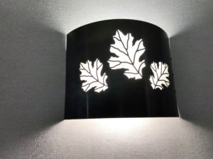 a black lamp with white leaves