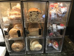 a group of bread and pastries in a display case