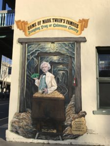 a mural of a man holding a plant