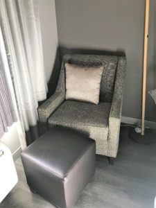 a chair and ottoman in a room