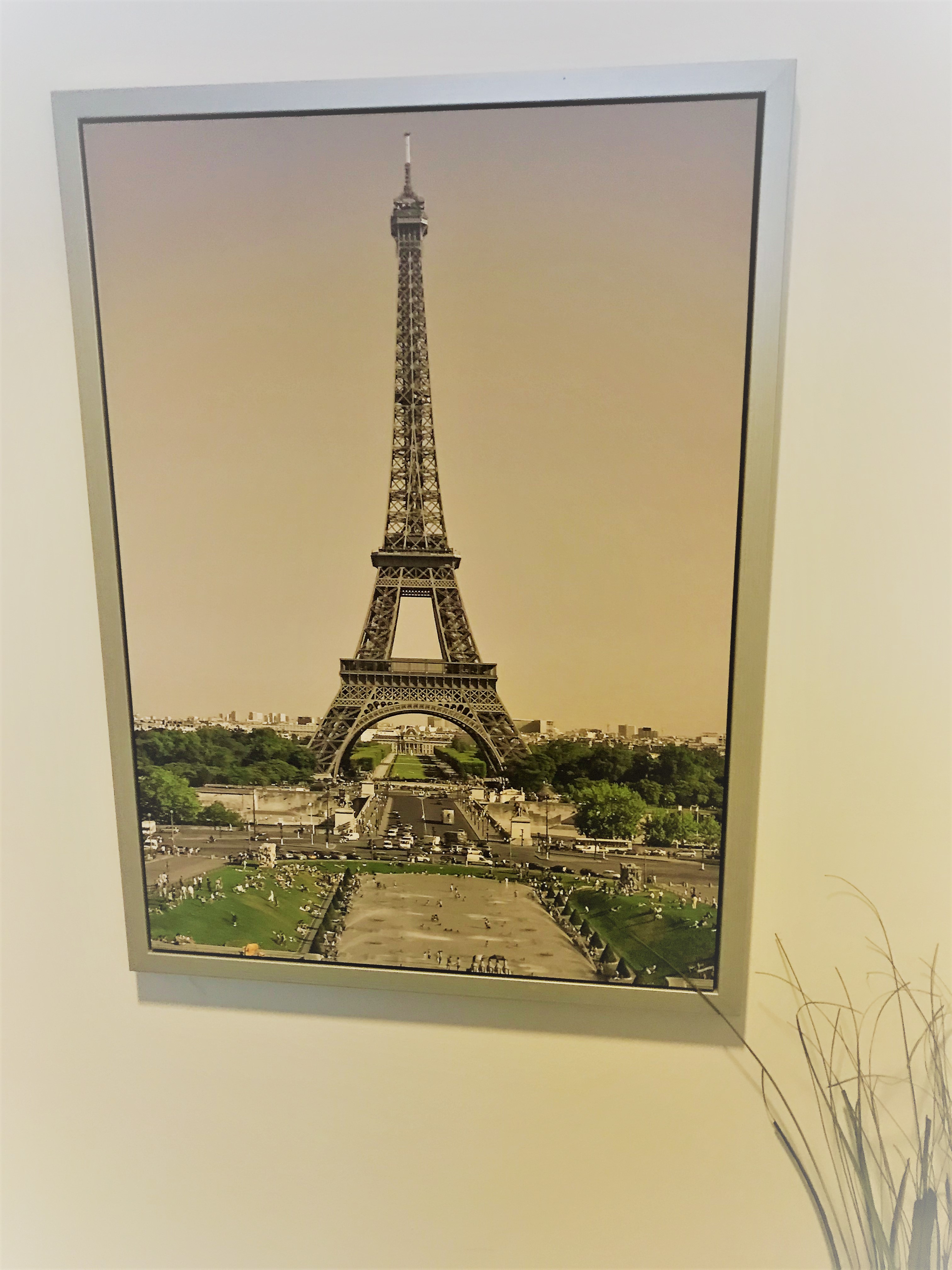 a picture of Eiffel Tower on a wall