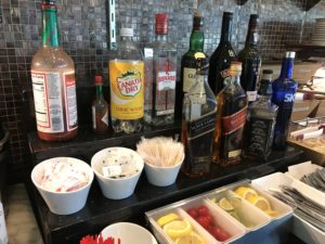 a bar with bottles of alcohol and food