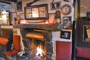 a fireplace in a room with pictures on the wall