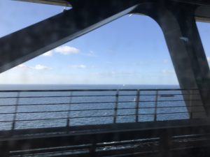 a view of the ocean from a train