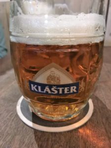 a glass of beer on a coaster