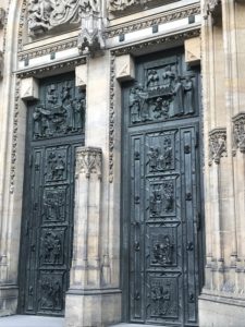a large black doors with carvings on them