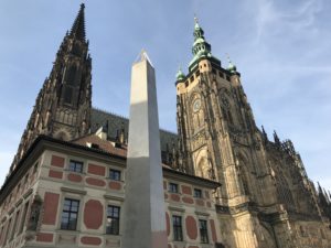 a tall stone obelisk in front of a building