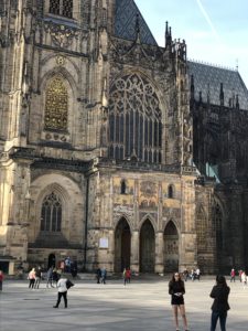 a large stone building with people walking around