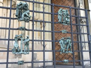 a metal gate with statues on it