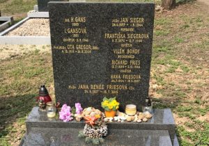 a tombstone with flowers and candles
