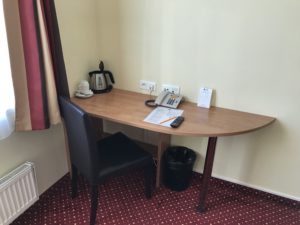 a desk with a chair and a telephone on it