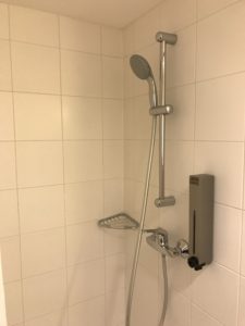 a shower with a silver shower head