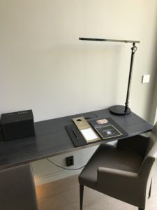 a desk with a lamp and a box