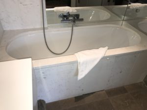 a bathtub with a towel on the side