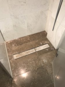 a tile floor with a drain