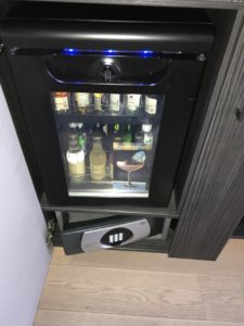 a mini fridge with a glass door