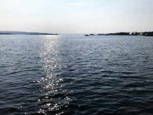 a body of water with land in the background