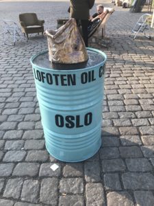a barrel with a statue on top