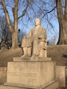 a statue of a man sitting in a chair