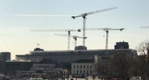 a group of cranes in front of a building