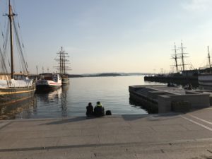 two people sitting on a dock